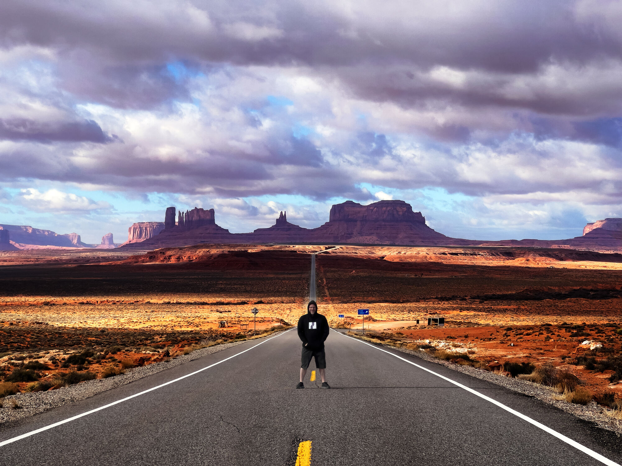 Matthew Anthony standing on the highway into Monument Valley